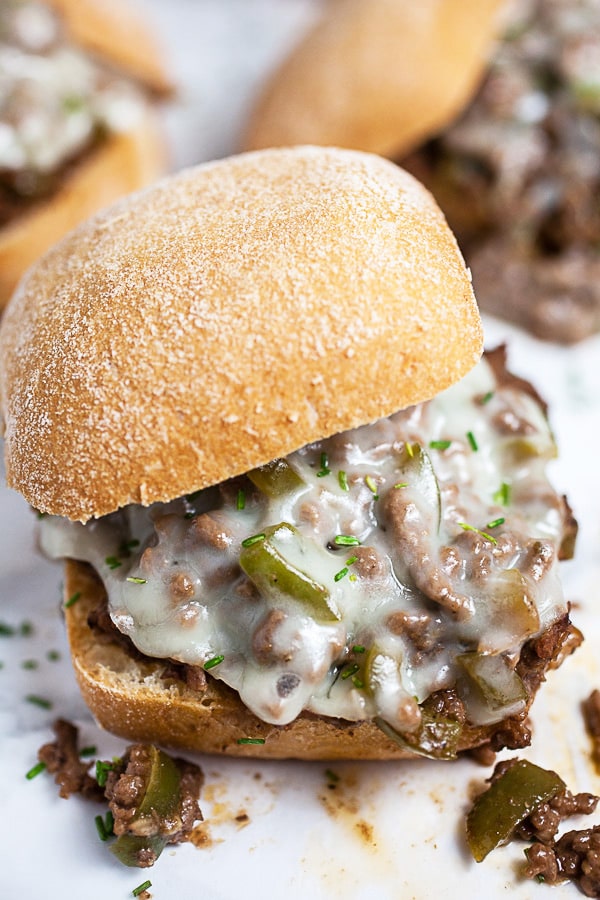 Philly cheesesteak sloppy joes with melted cheese on buns.