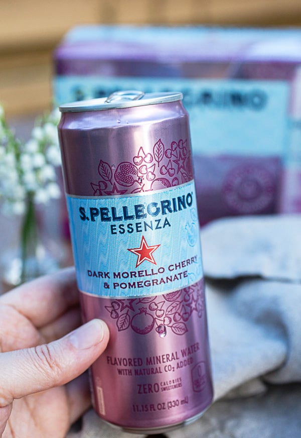 Hand holding can of sparkling water.