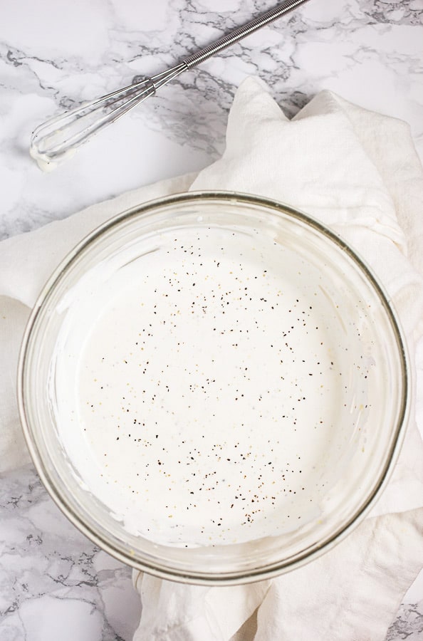 Creamy sauce in small glass bowl.