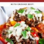 Pizza stuffed peppers in white bowl with fork garnished with fresh basil.