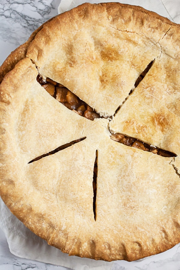 Baked apple pie with slits cut in the top crust.