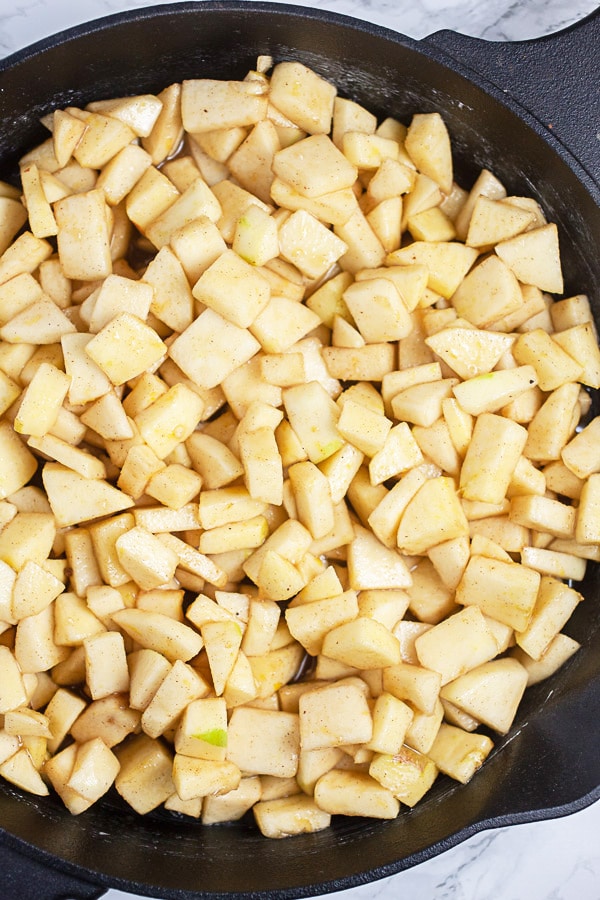 Uncooked diced apples in large cast iron skillet.