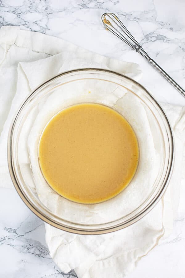 Maple mustard dressing in small glass bowl.