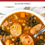 Sausage lentil kale soup in white bowl with spoon.