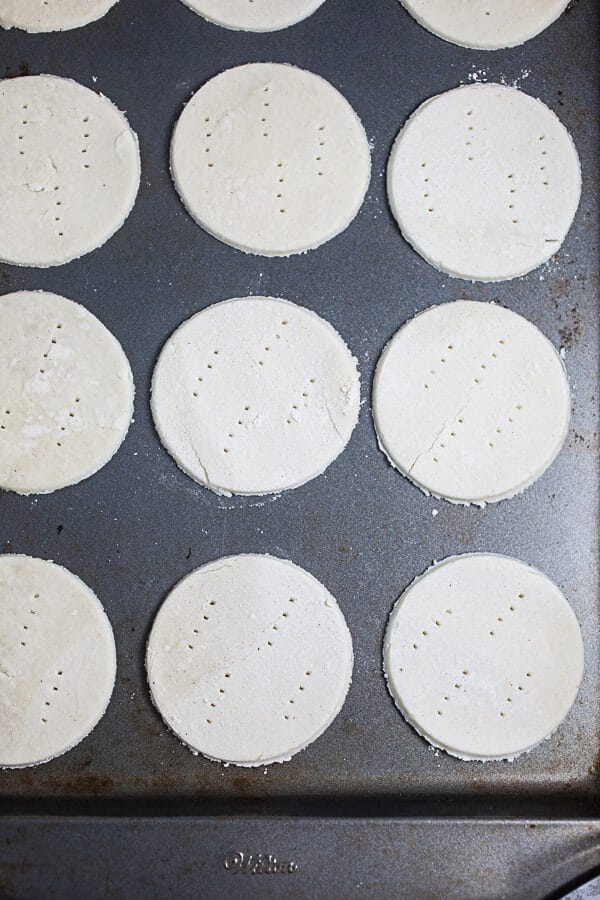 Gluten free Puff Pastry rounds on metal baking sheet.