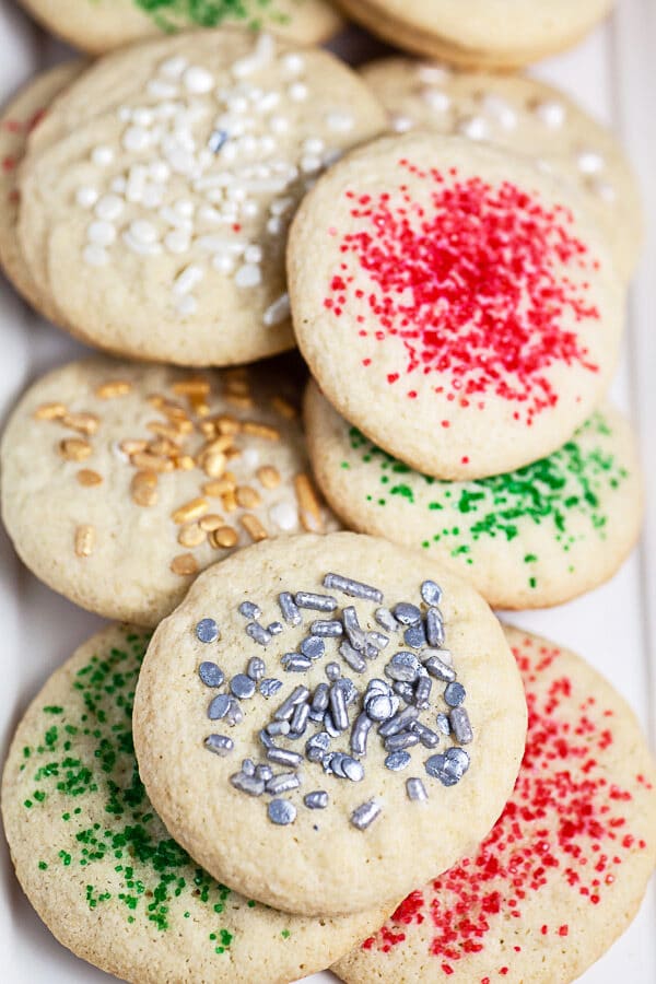 Crispy old fashioned sugar cookies with sprinkles on white serving platter.