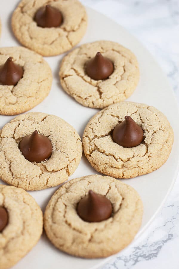 Peanut butter blossom cookies on white plate.
