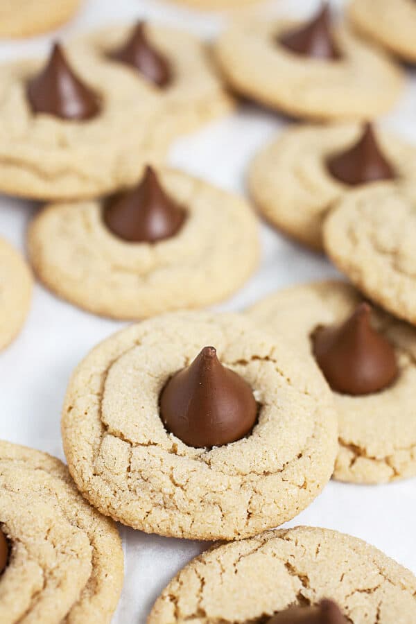 Peanut butter blossom cookies on white surface.