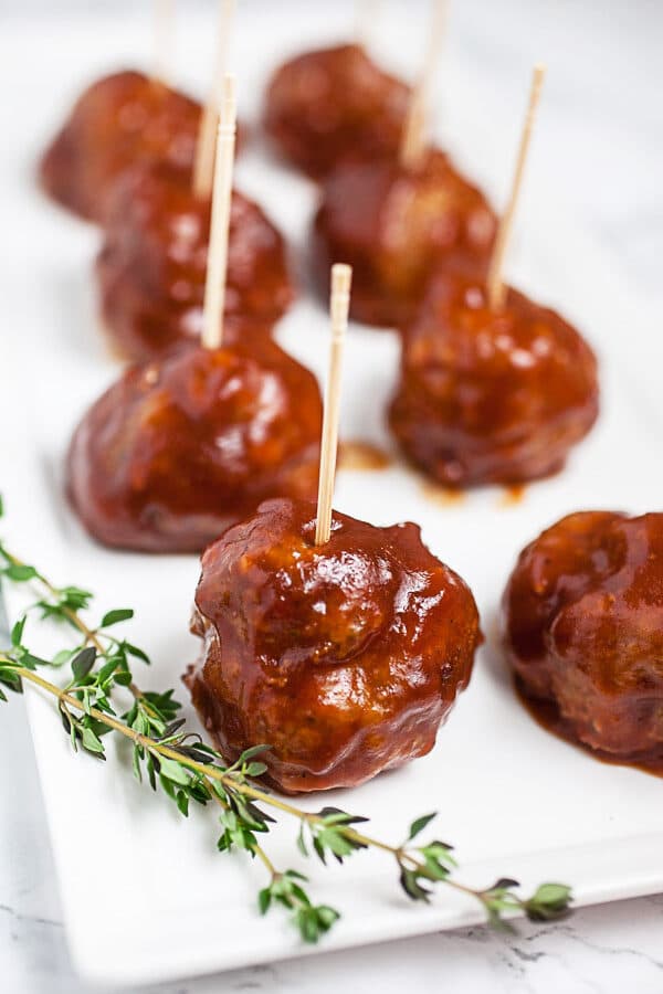 BBQ turkey meatballs with toothpicks on white serving platter.