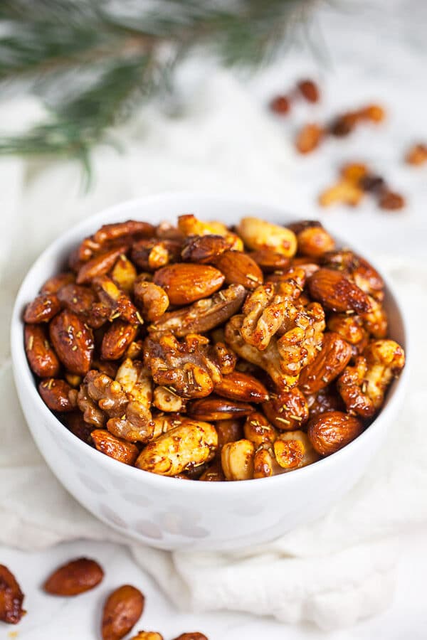 Oven roasted mixed nuts in small white bowl.