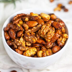 Spiced maple roasted mixed nuts in small white bowl.
