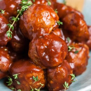 Slow cooker BBQ turkey meatballs in blue bowl.