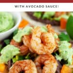 Cajun shrimp tacos with avocado sauce on corn tortillas.