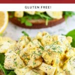 Open-faced egg salad sandwiches with arugula garnished with fresh dill.