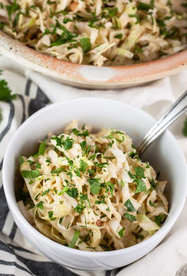 Southwest chipotle coleslaw in white bowl garnished with cilantro.