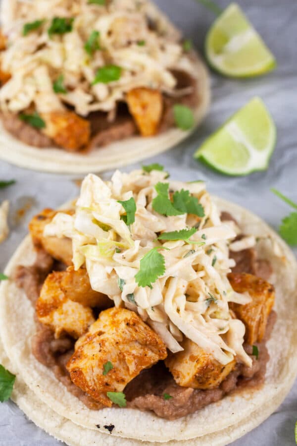 Chicken tacos topped with chipotle coleslaw.