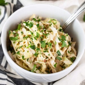 Southwest chipotle lime coleslaw in small white bowl garnished with cilantro.