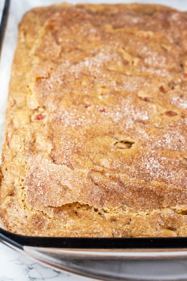 Baked rhubarb cake in rectangular glass cake pan.