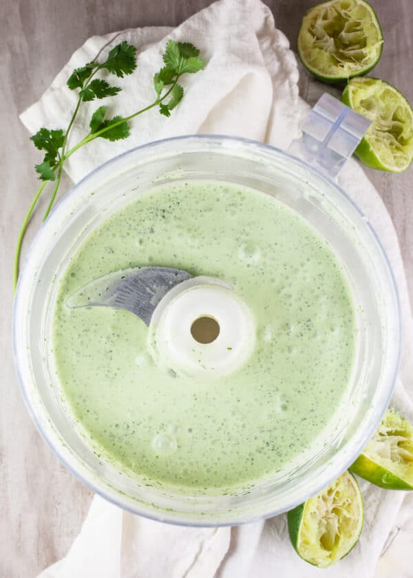 Sour cream, cilantro, and lime dressing in food processor.