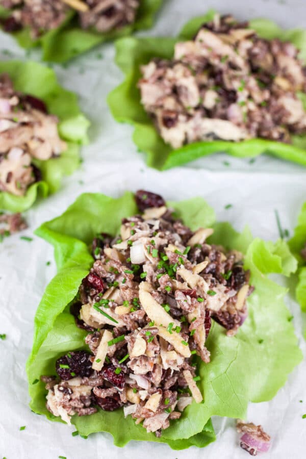 Rotisserie chicken, wild rice, cranberry, and almond salad in lettuce cups.