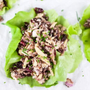 Rotisserie chicken, wild rice, cranberry, and almond salad in lettuce cups.