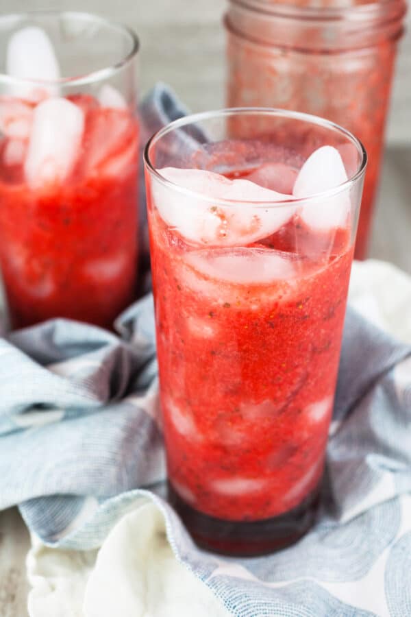 Strawberry mint puree with ice in tall glasses.