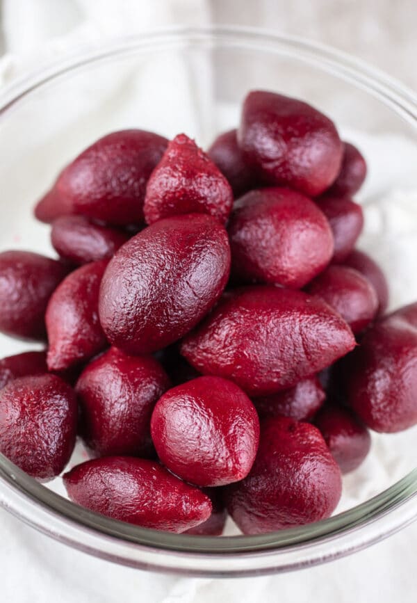 Pickled beets in small glass bowl.