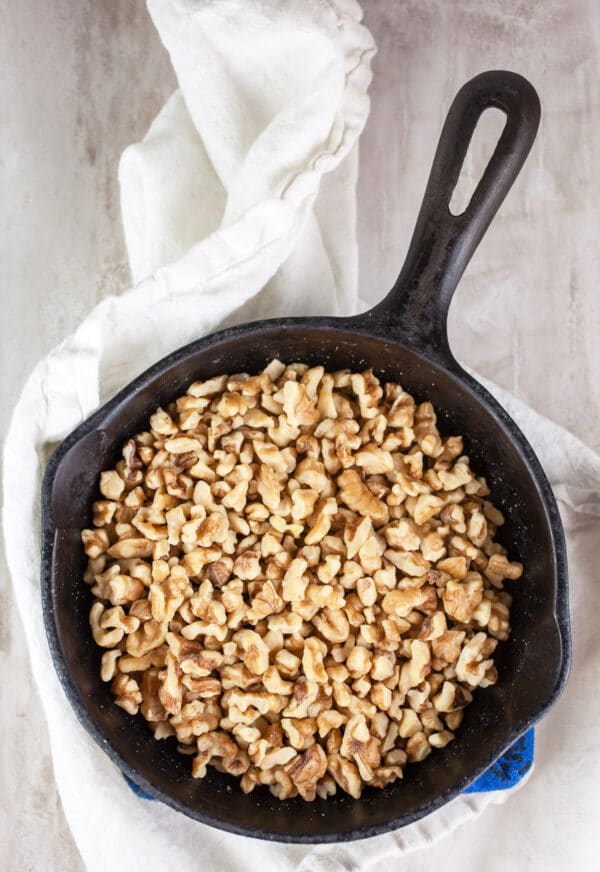 Toasted walnuts in small cast iron skillet.