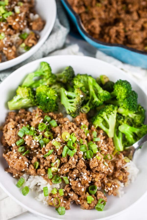 Ground teriyaki turkey with broccoli over rice in white bowl.