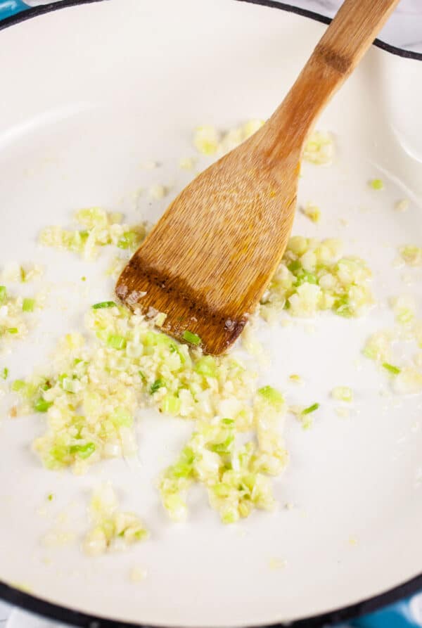 Garlic, scallions, and ginger sautéed in white cast iron skillet.