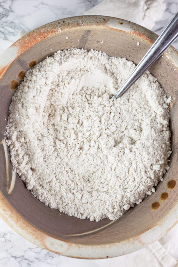 Gluten free flour blend, baking soda, and kosher salt combined in ceramic bowl.