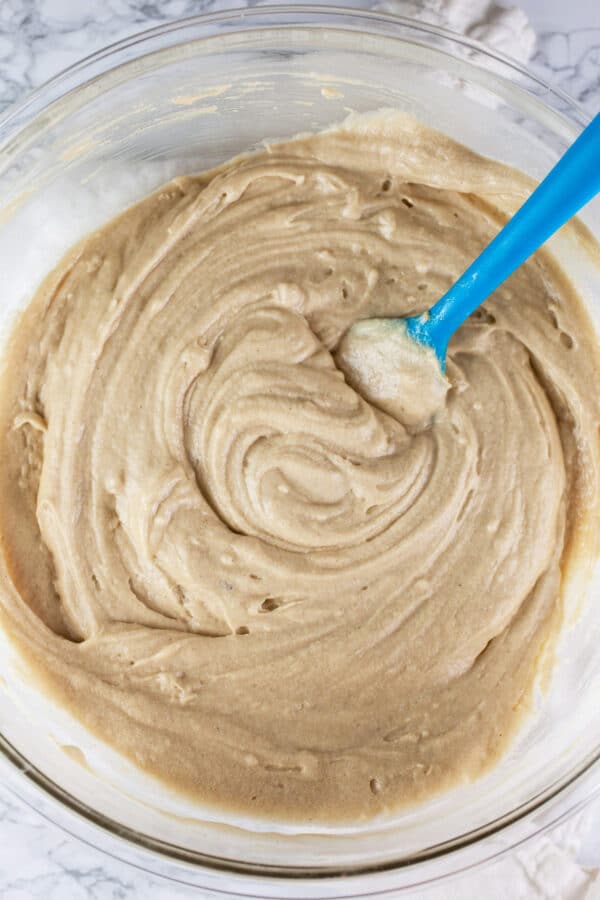 Wet and dry cake ingredients combined in large glass bowl.