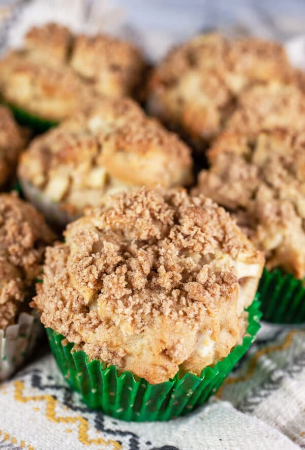 Gluten free apple cinnamon streusel muffins on towel.