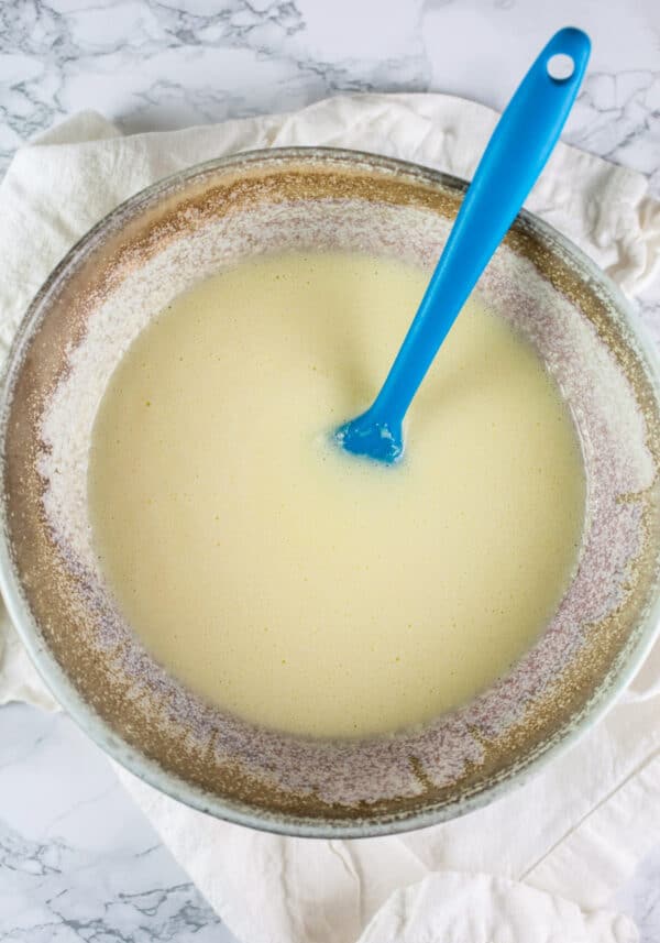 Wet muffin ingredients combined in ceramic bowl.