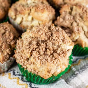 Gluten free streusel apple muffins on towel.