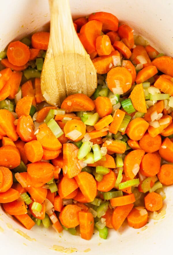 Sautéed garlic, onions, celery, and carrots in white Dutch oven.