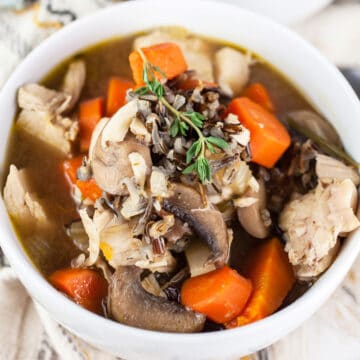 Autumn wild rice soup in small white bowl.