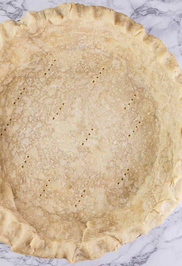 Par-baked gluten free pie crust in pie pan.
