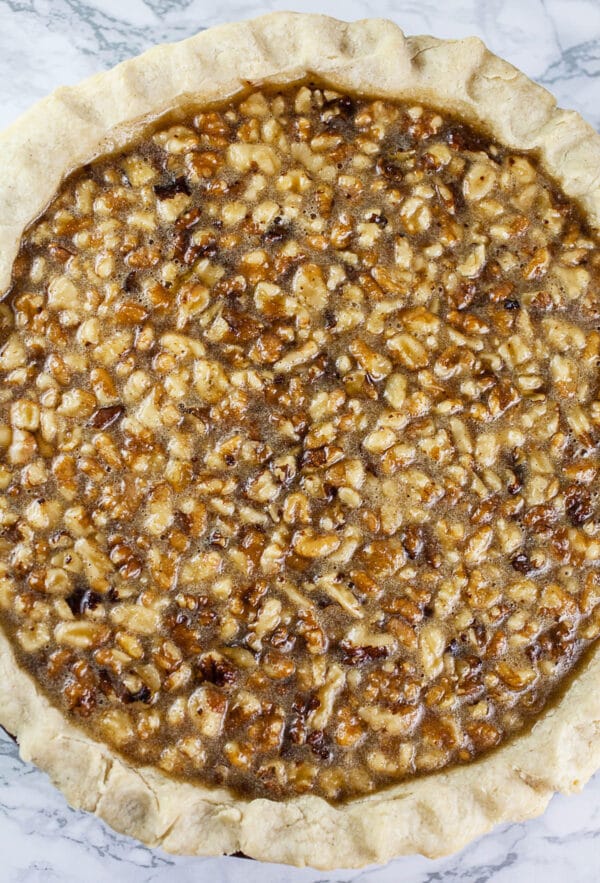 Unbaked maple walnut pie in pie pan.
