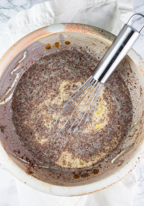 Egg and milk mixture with spices in ceramic bowl.