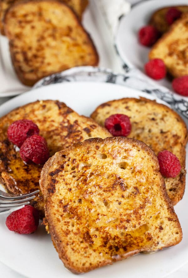 Gluten free skillet cardamom French toast with fresh raspberries.