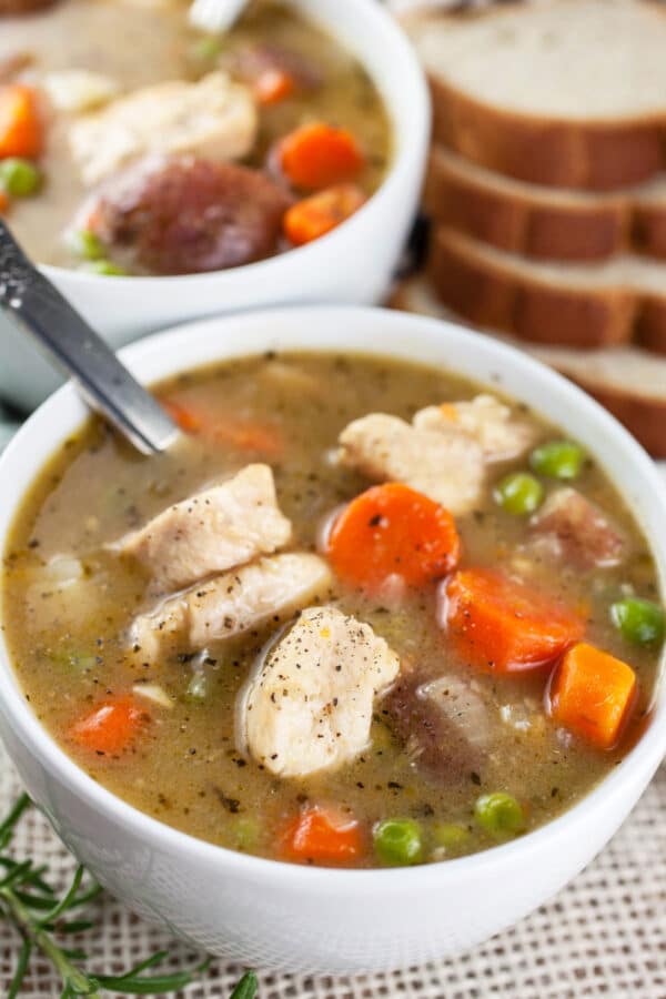 Gluten free chicken stew in small white bowls with bread.