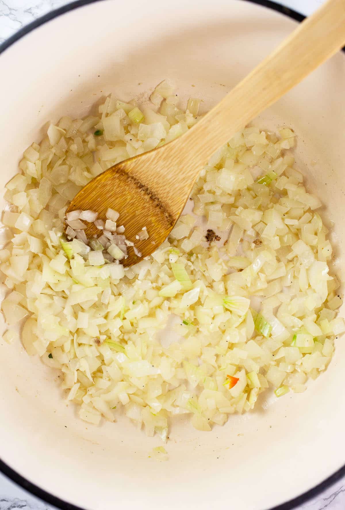 Garlic and onions sautéed in Dutch oven.