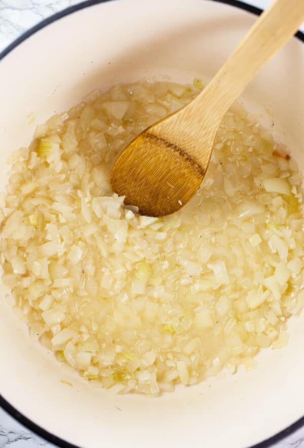 Garlic and onions sautéed with white wine in Dutch oven.
