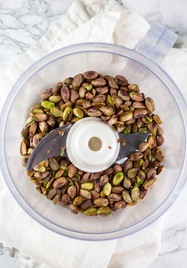 Roasted pistachios in food processor.