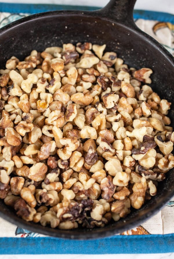 Chopped walnuts toasted in small cast iron skillet.