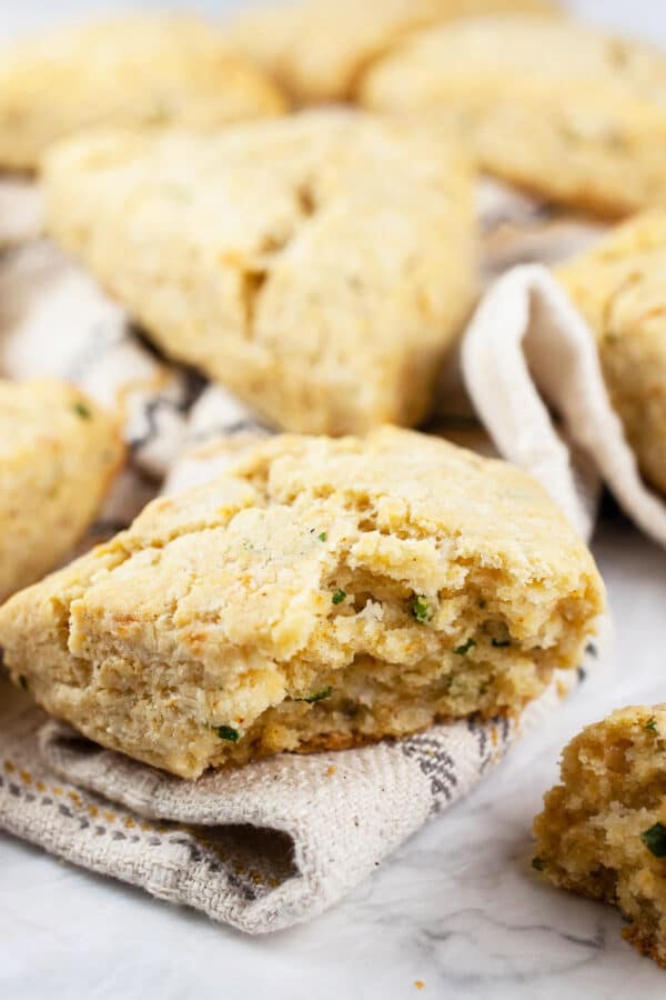 Gluten free cheese scones with chives on white towel.