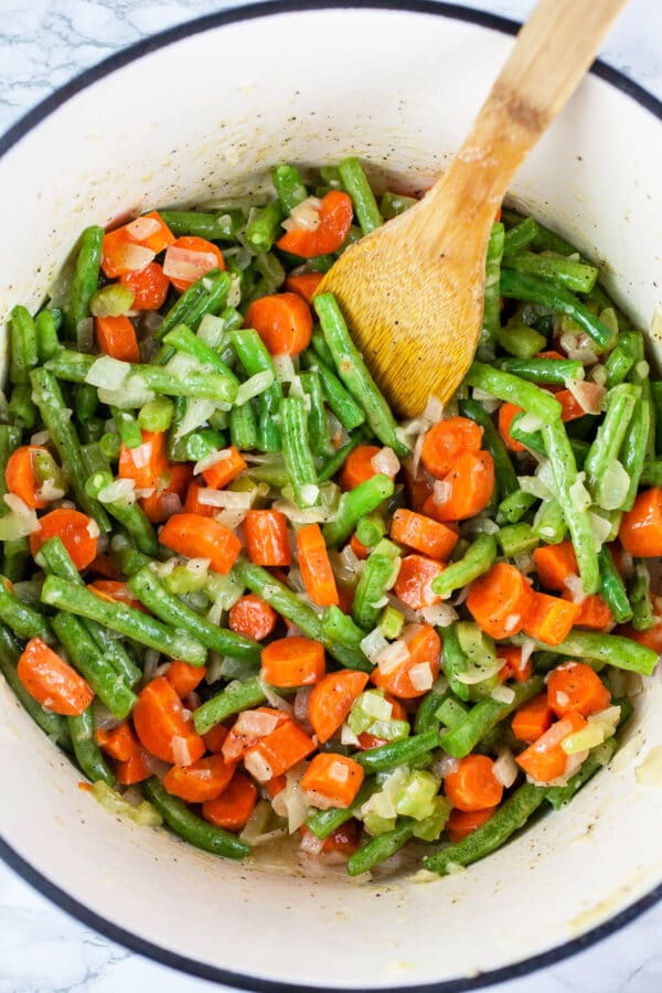 Carrots and green beans sautéed in Dutch oven.