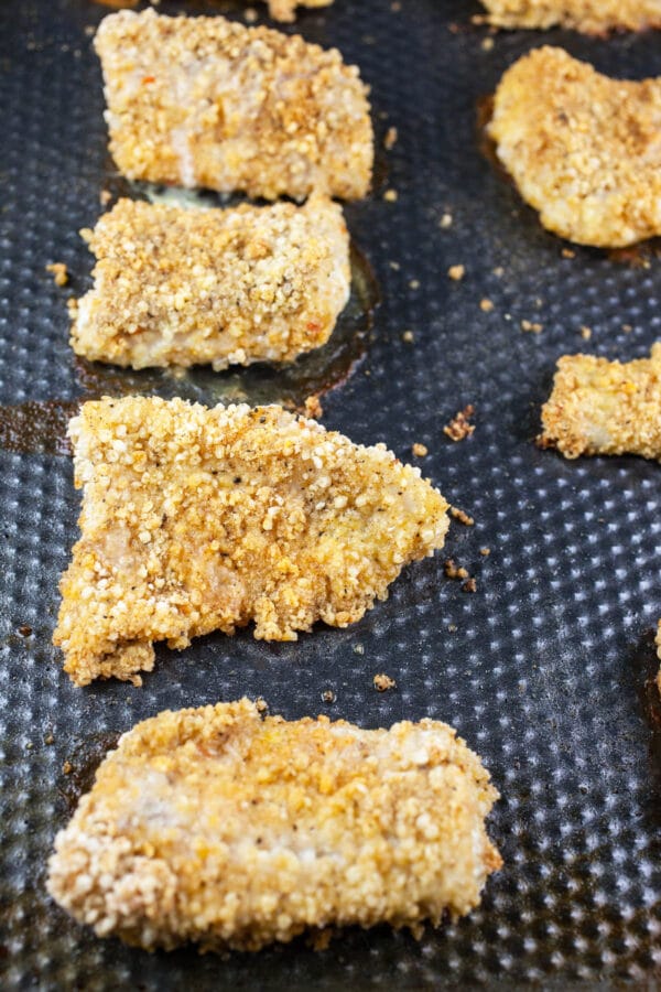 Baked fish fillets on baking sheet.