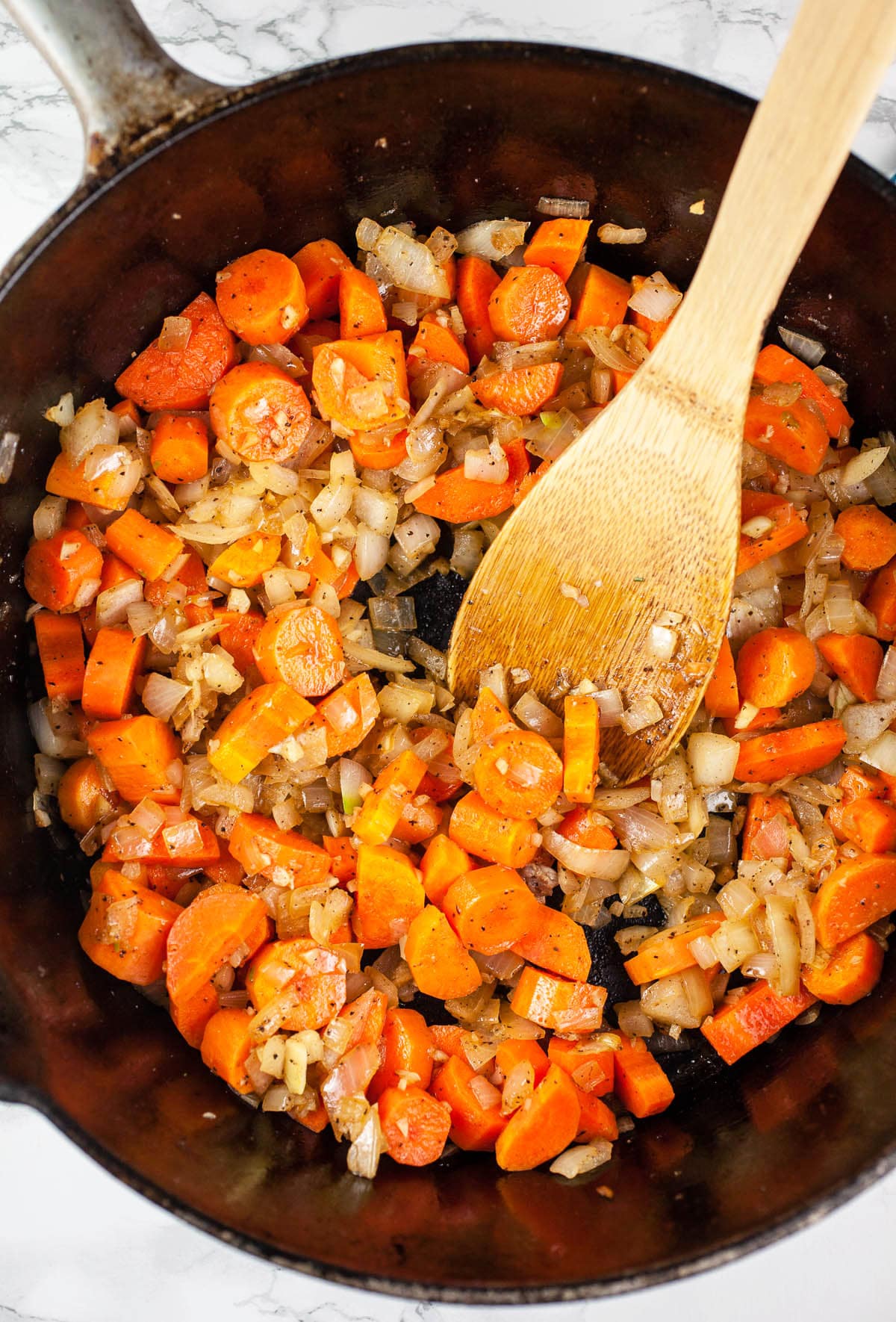 Sautéed garlic, onions, and carrots in cast iron Dutch oven.